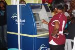 A bank staff seen using an ATM at an exhibition showcasing banking technologies and services in Lagos