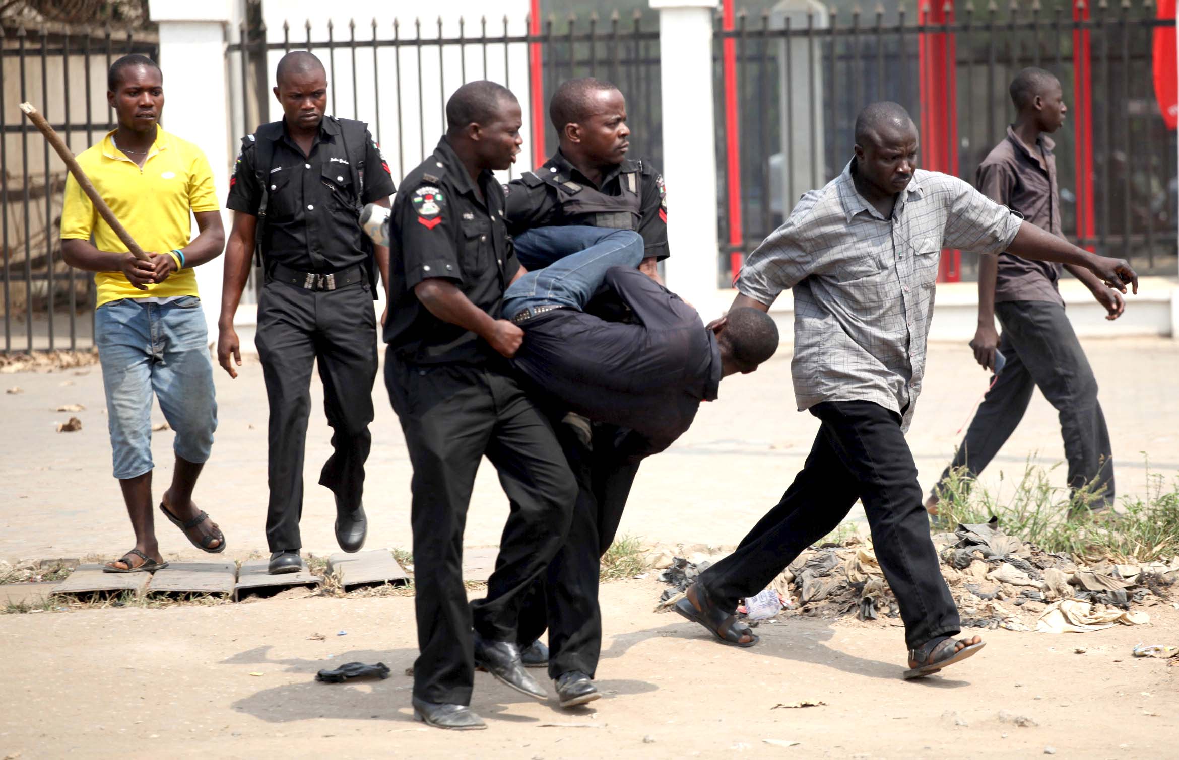 A man is arrested by the police for looting on the fourth day of a nationwide strike against the removal of the petrol subsidy in Lagos
