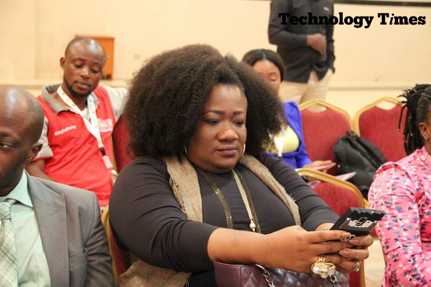 A lady seen looking at a smartphone the AWIEF 2016 event in Lagos