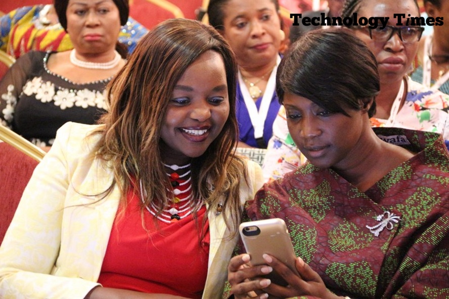 Technology Times photo shows two women looking at a mobile phone at the Africa Women Innovation and Entrepreneurship Forum (AWIEF 2016) held last week in Lagos